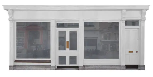 Shop with white painted wooden front with shop windows and front door cut-out on white background