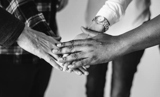 istock Diverse people joining hands together teamwork and community concept 1019735100