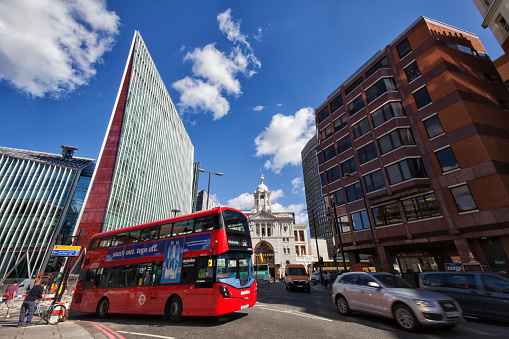 July 28, 2018 Victoria Palace theatre and modern buildings and a double-decker bus in the street in London on a summer afternoon, England, UK.
