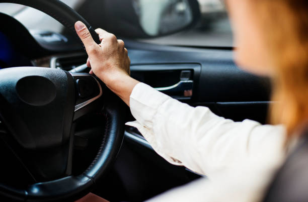 istock Woman driving a car on a road 1019749232