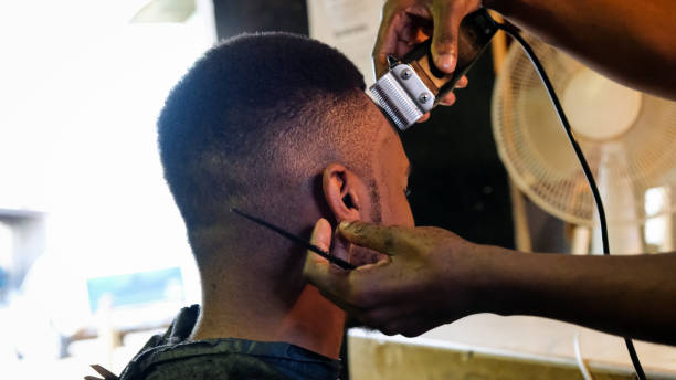 istock Barber cutting his clients hair 1019754640