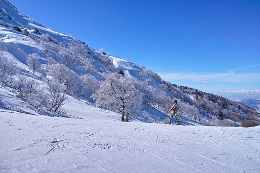 Yamagata, Japan - 7 March 2018: Scenery in the early March of Zao Onsen Ski Resort in Yamagata Prefecture of Japan. Skier before skiing with a beautiful paradise slope at the Zao Onsen ski area.