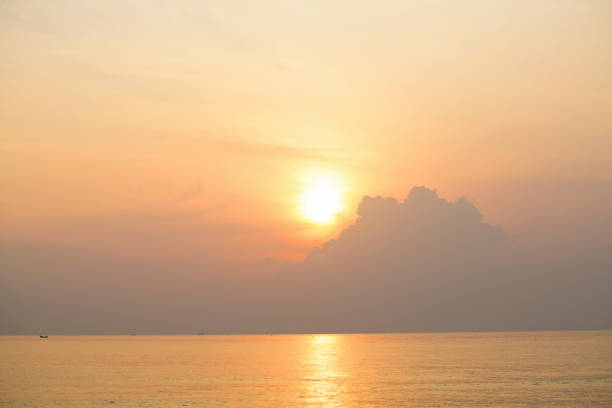 Sunrise in sea the morning  amidst the clouds and the sky is beautiful quiet atmosphere feeling lonely