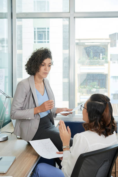 istock Business women discussing financial documents 1019773146