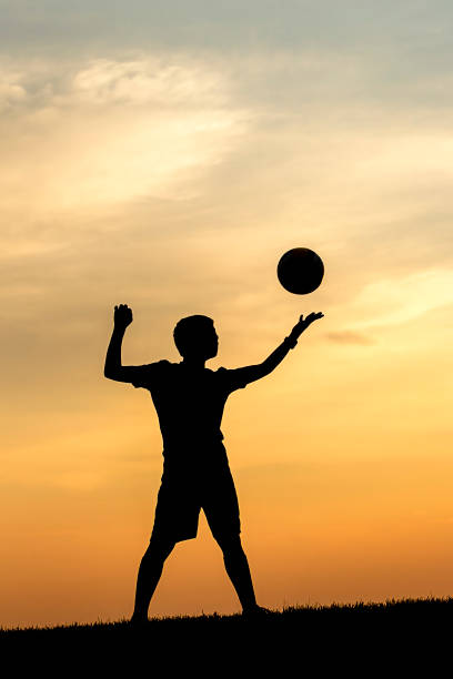 istock Serving the volleyball at sunset. 1019777850