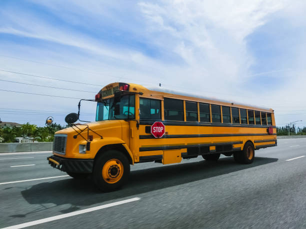 istock School buss on freeway road at Orlando, Florida, USA 1019778278