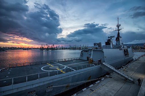 Part of frigate naval forces at sunset at the port. Warship