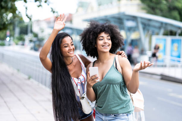 istock Woman with smart phone standing on street 1019785676