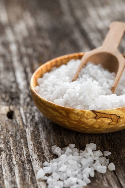 istock Sea salt on wooden plate on rustic table 1019788640