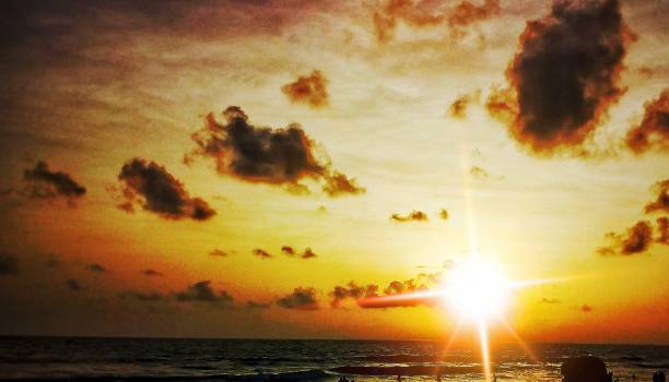 istock Sun set in mumbai juhu beach 1019788958
