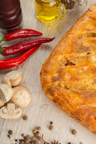 istock Meat pie on a wooden background with ingredients 1019794606