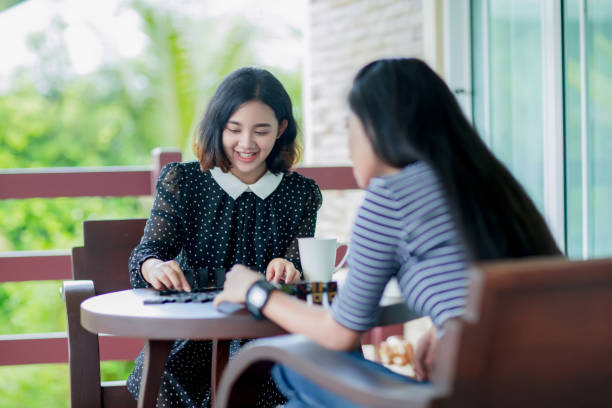 istock Young asian girls playing domino game 1019794746