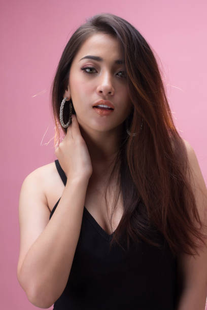 istock young asian woman smiling on pink background 1019794850
