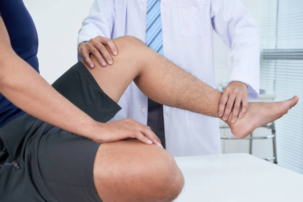 istock Doctor checking leg of patient 1019805040