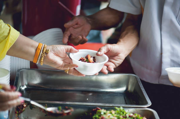 istock feeding to hand the poor helping  beggar in social. poverty concept 1019810896