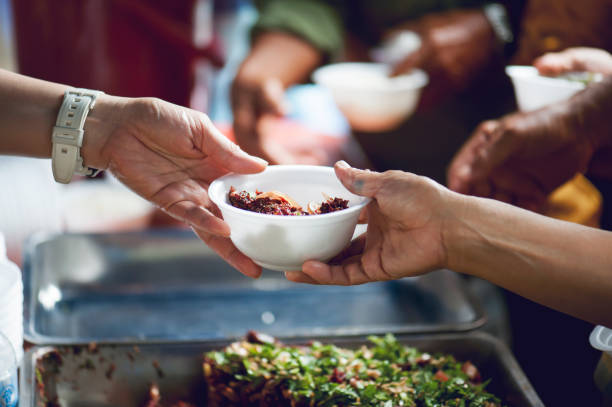 istock feeding to hand the poor helping  beggar in social. poverty concept 1019810918
