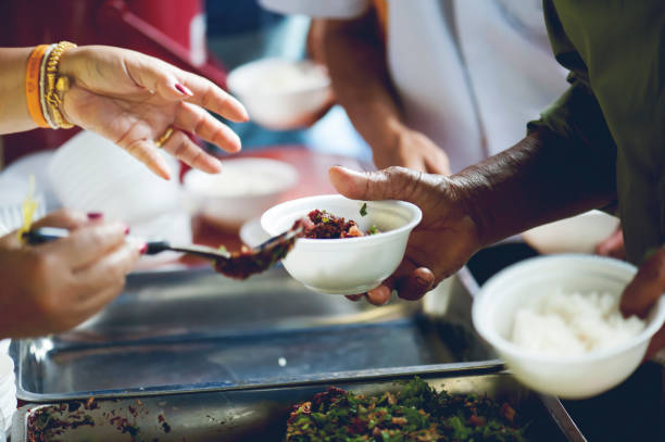 istock feeding to hand the poor helping  beggar in social. poverty concept 1019811024