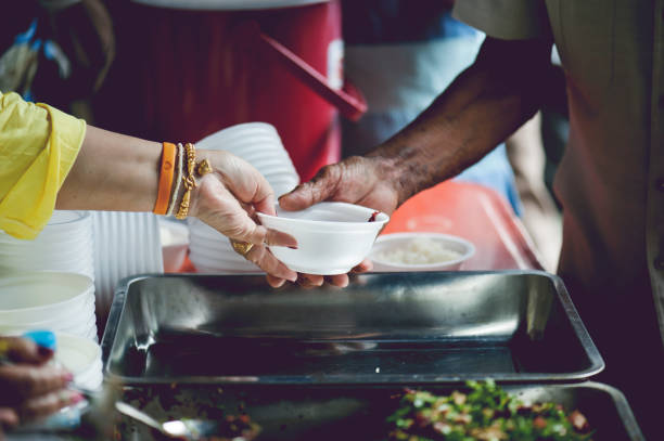 istock feeding to hand the poor helping  beggar in social. poverty concept 1019811030