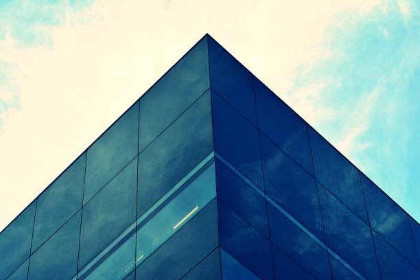 istock Modern office building facade abstract fragment, shiny windows in steel structure, retro stylized colorful tonal filter effect 1019813534