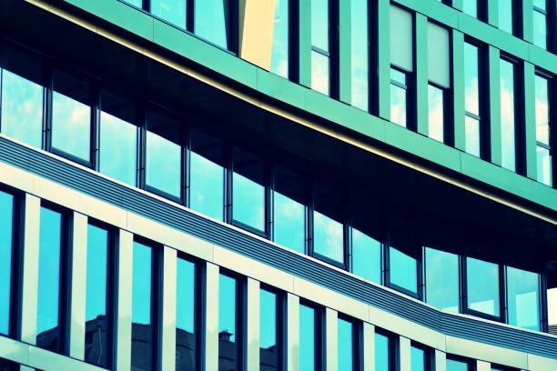istock Modern office building facade abstract fragment, shiny windows in steel structure, retro stylized colorful tonal filter effect 1019813776