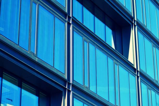 istock Modern office building facade abstract fragment, shiny windows in steel structure, retro stylized colorful tonal filter effect 1019814062