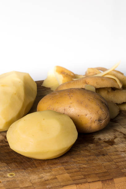 istock Peeling cooking potatoes on a wooden board 1019814186