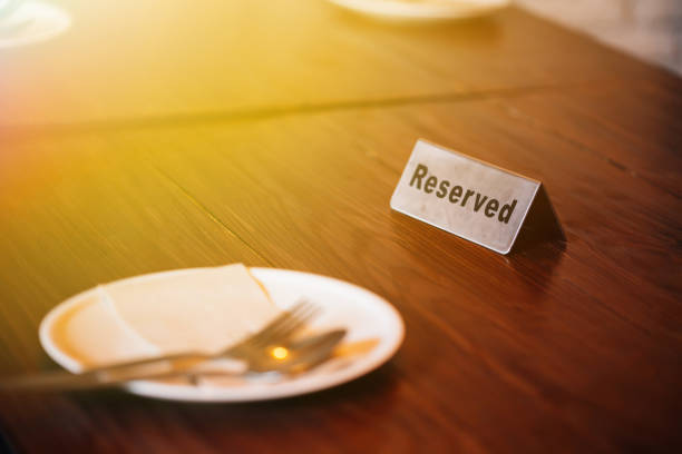 istock 'Reserved' Sign on dining table in restaurant with spoon, fork and plate. 1019817374