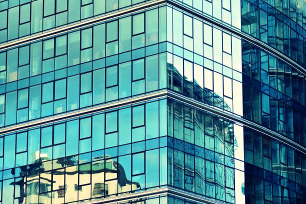 istock Modern office building facade abstract fragment, shiny windows in steel structure, retro stylized colorful tonal filter effect 1019817874