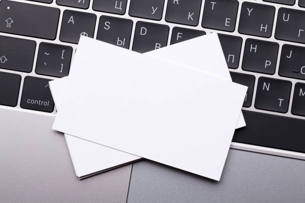 istock Blank business cards over laptop keyboard 1019825640