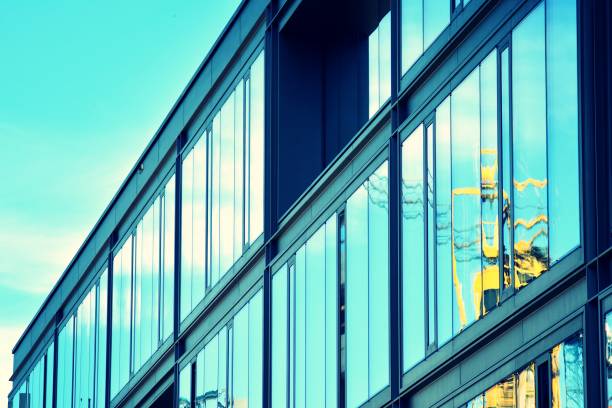 istock Modern office building facade abstract fragment, shiny windows in steel structure, retro stylized colorful tonal filter effect 1019826036
