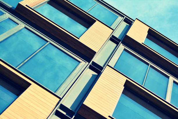 istock Modern office building facade abstract fragment, shiny windows in steel structure, retro stylized colorful tonal filter effect 1019826146