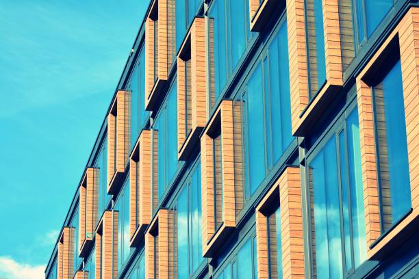 istock Modern office building facade abstract fragment, shiny windows in steel structure, retro stylized colorful tonal filter effect 1019826452