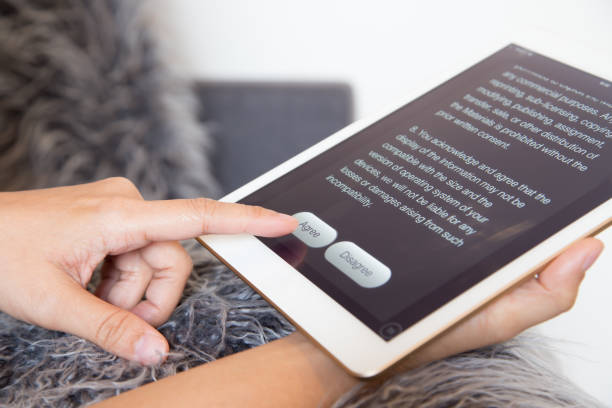 Woman finger click agree button on tablet screen.