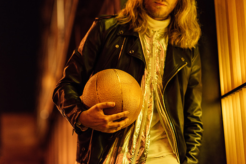 Cropped Shot Of Stylish Man In Leather Jacket Holding Golden