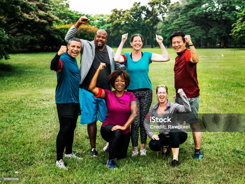 Group of cheerful diverse friends in the park Exercising Stock Photo