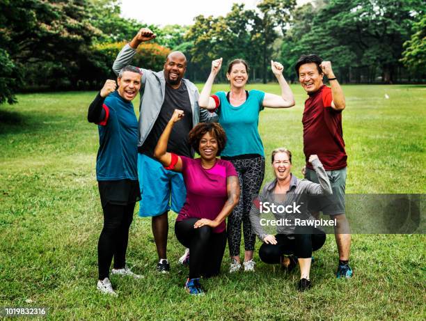 Group Of Cheerful Diverse Friends In The Park Stock Photo - Download Image Now - Exercising, Group Of People, Multiracial Group