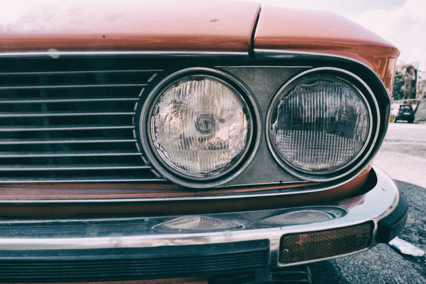 istock Headlight of a red vintage classic car. 1019835262