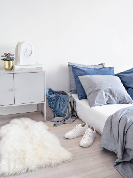 istock Light bedroom with unmade bed and clothes. 1019835342