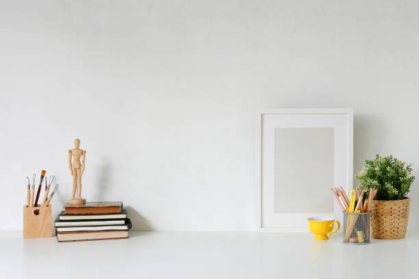istock Stylish workspace with poster, book and gadget. Workplace desk and copy space. 1019838324