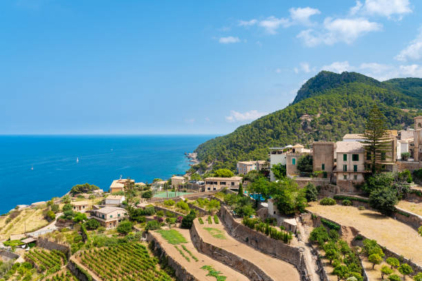village of Banyalbufar on balearic island of Mallorca village of Banyalbufar on balearic island of Mallorca, Spain on beautiful summer day against blue sea and clear sky banyalbufar stock pictures, royalty-free photos & images