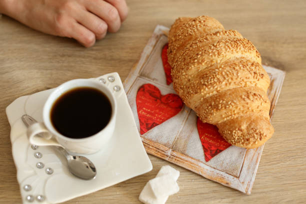 istock Woman having croissant and coffee for breakfast 1019842724