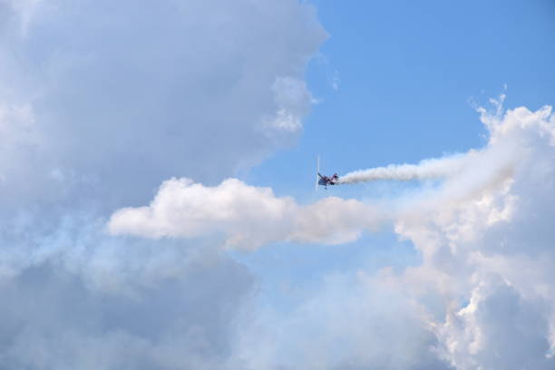 istock One small helicopter with its rotors on flying through the sky while emmiting a lot of smoke while flying below cloudy summer sky seen during one of trips in Poland 1019845376