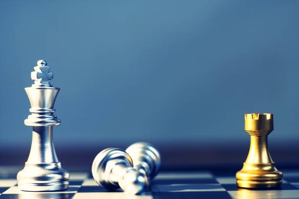 istock King surrounding with enemy, knight, queen, rook as check, business competitive concept, cheeseboard game concept 1019845738