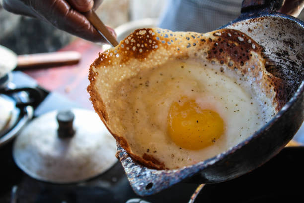 Sri lankan egg hopper freshly cooked - Ella, Sri Lanka Sri lankan egg hopper freshly cooked - Ella, Sri Lanka sri lankan culture stock pictures, royalty-free photos & images