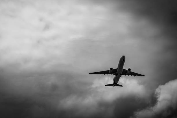 istock Commercial airplane on grey sky and clouds with copy space. Failed vacation. Hopeless and despair concept. Moody sky and transport plane. Sad emotional scene. Background of aircraft flight. 1019855666