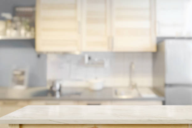 istock White marble countertops with modern kitchen room background. 1019858000