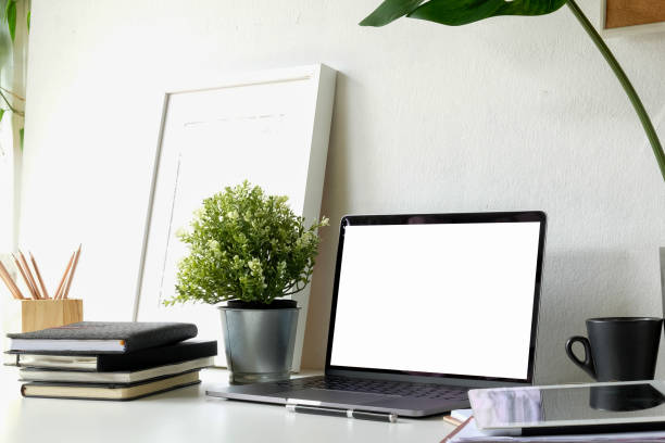 istock Structural engineer and architect desktop with blank screen laptop and safety helmet 1019858978
