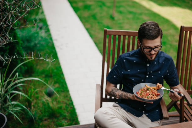 istock Man having lunch in a garden on a sunny summer day 1019859096