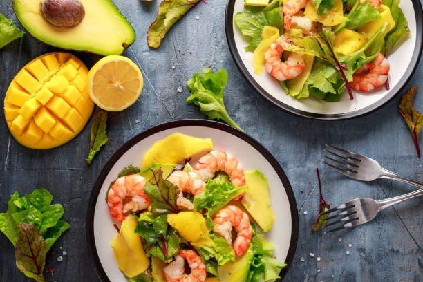 fresh shrimps, avocado, mango salad with lettuce green mix, herbs, lemon, healthy food. - morning tomato lettuce vegetable imagens e fotografias de stock