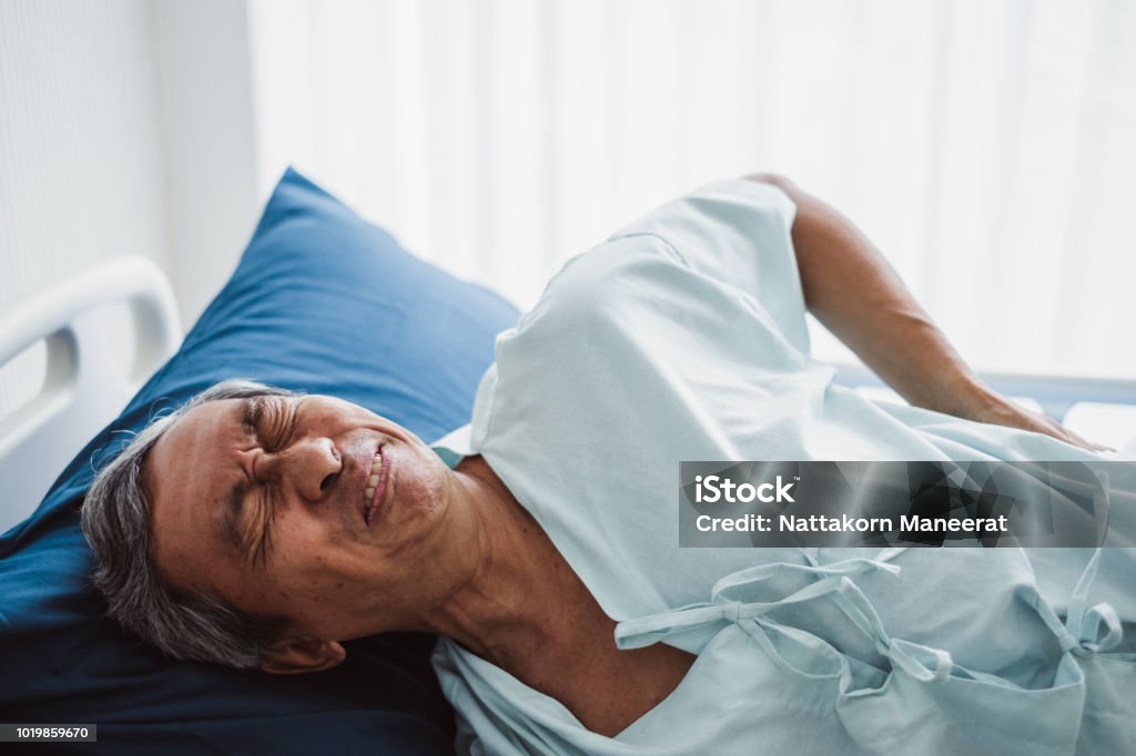 Old senior asian patient suffering from back pain, back ache Pain Stock Photo
